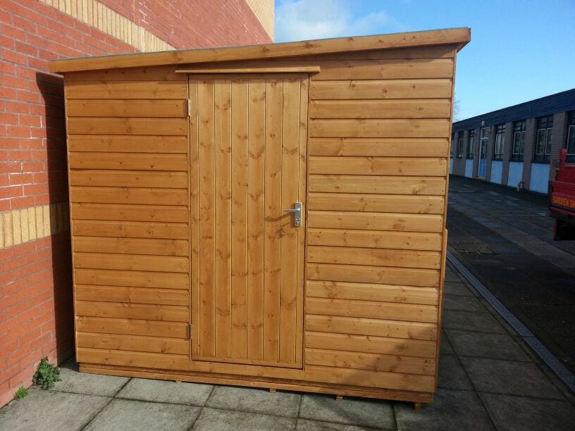 Timber pent shed with double doors on a paved area