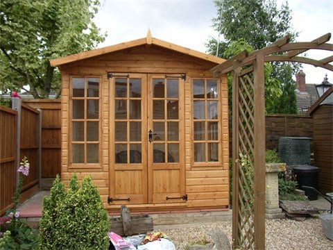 Timber summer house with Georgian-style glazed doors and trellis
